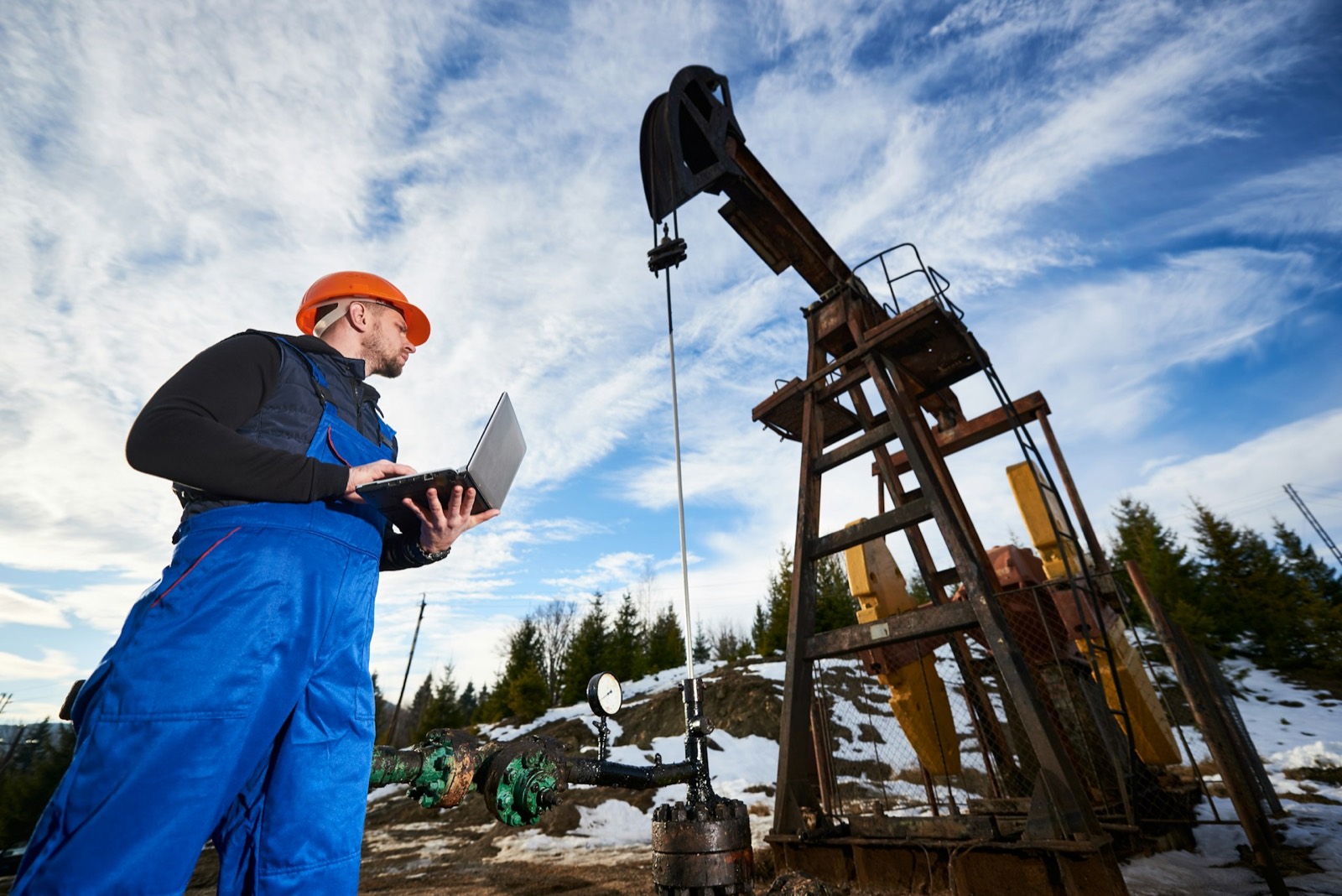 Field technician at an oil well pumpjack