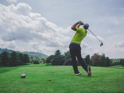 Golfer mid-swing on a fairway
